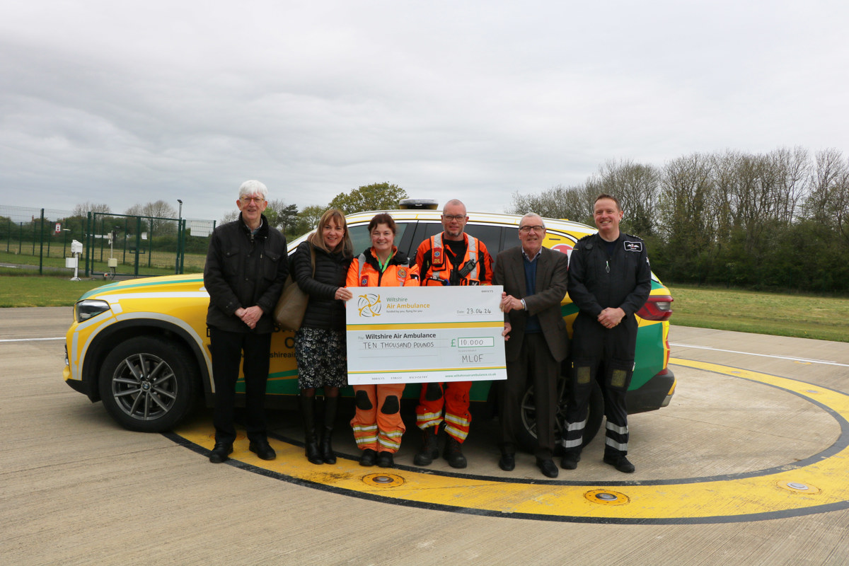 A cheque presentation from Malmesbury League Of Friends with WAA's crew, in front of their critical care car