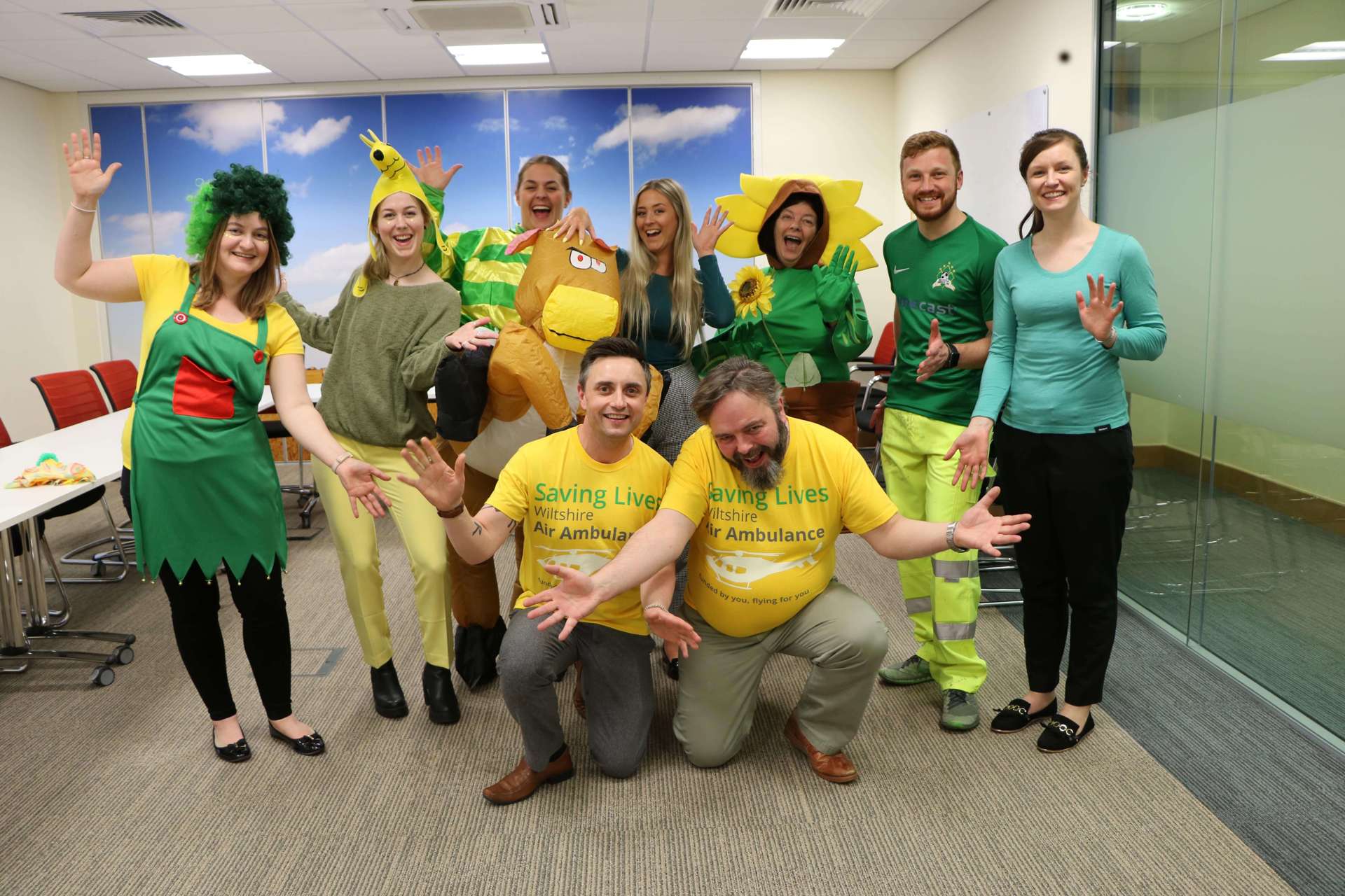 A group of colleagues wearing green and yellow attire to raise funds for Wiltshire Air Ambulance during Air Ambulance week. 