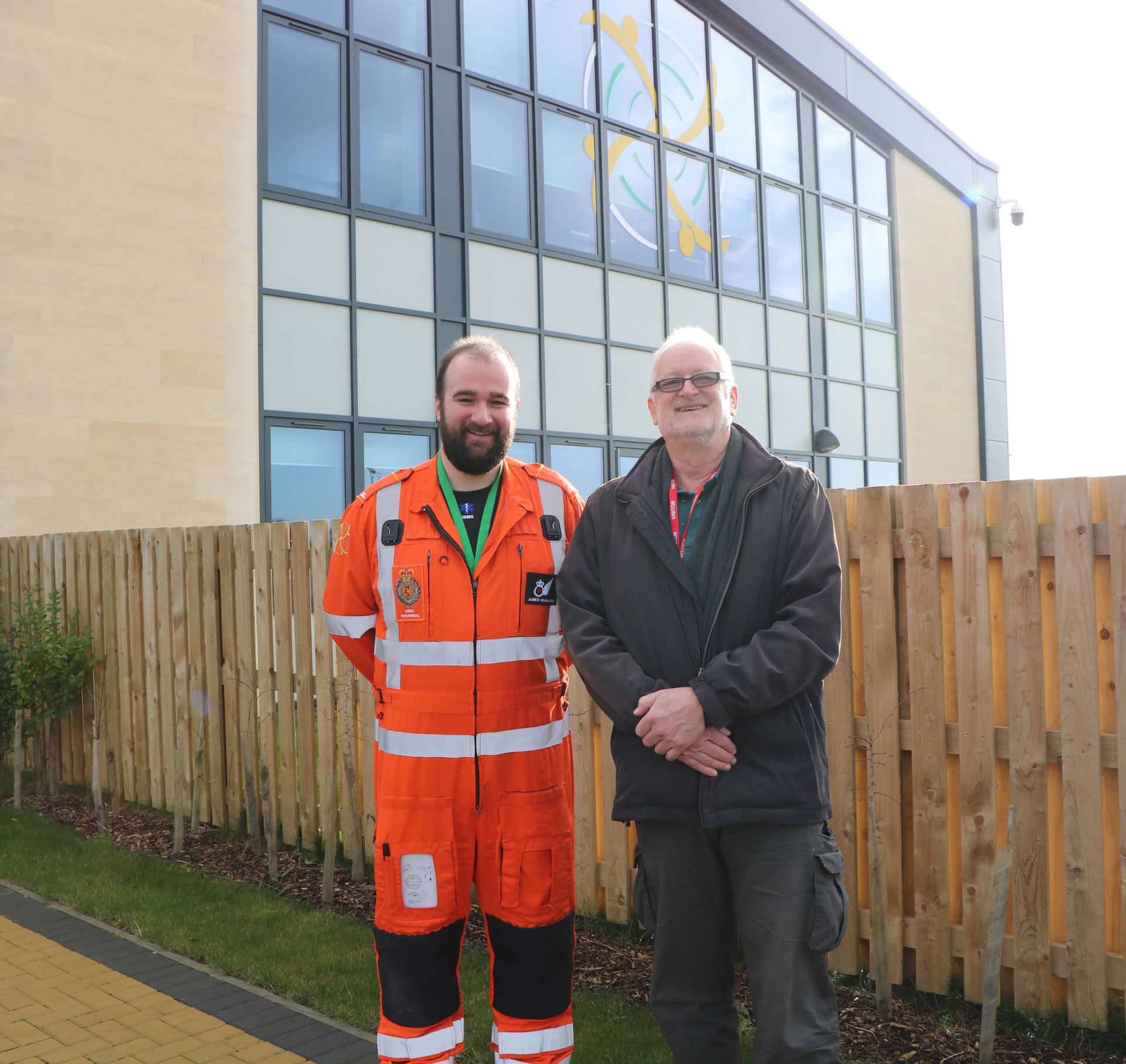 A former patient meeting a critical care paramedic outside the Wiltshire Air Ambulance airbase