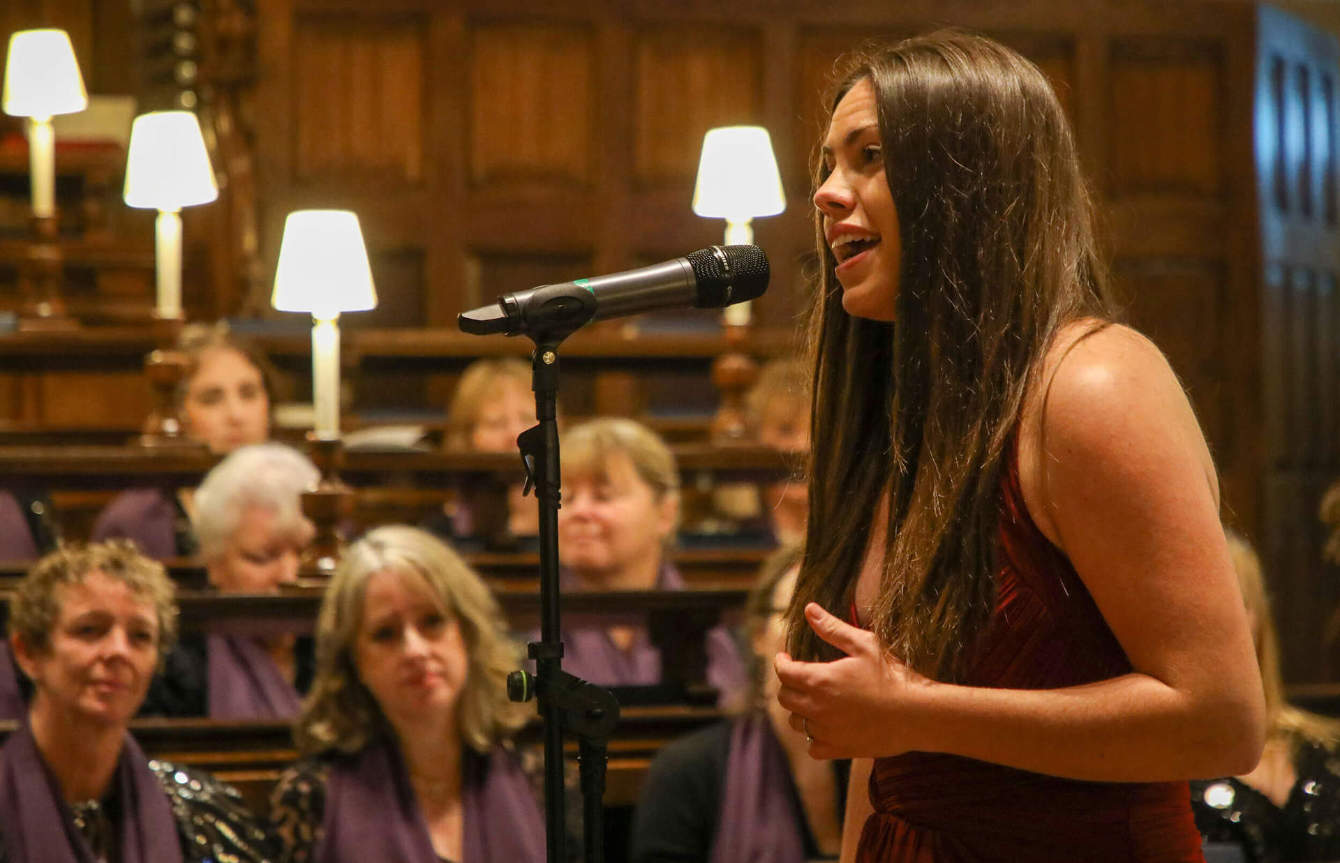 An opera singer singing at a carol concert