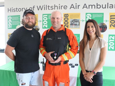 Critical care paramedic, Dan Tucker, receives his Platinum Jubilee Medal from ambassadors Tom Dunn and Shelley Rudman.