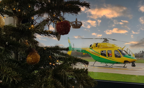 Christmas tree with helicopter in the background