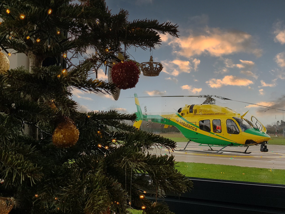 Christmas tree with helicopter in the background