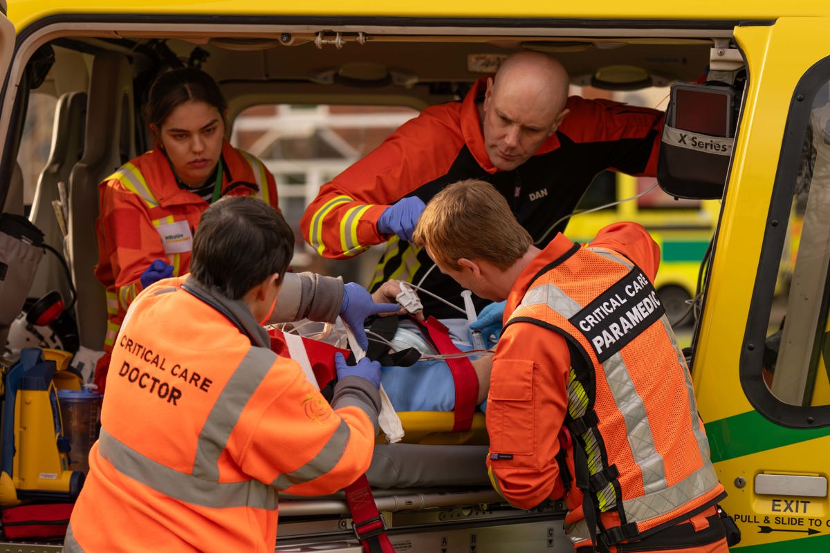 A team of critical care paramedics and doctors working on a patient on a stretcher in the back of the charity's helicopter