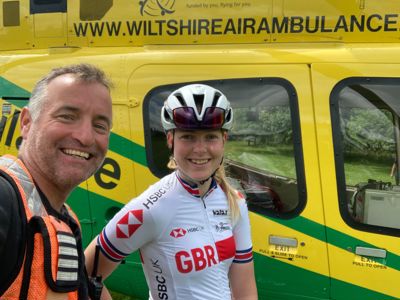 Pilot Si taking a selfie with Wiltshire Air Ambulance's ambassador Lauren Booth, with helicopter in the background