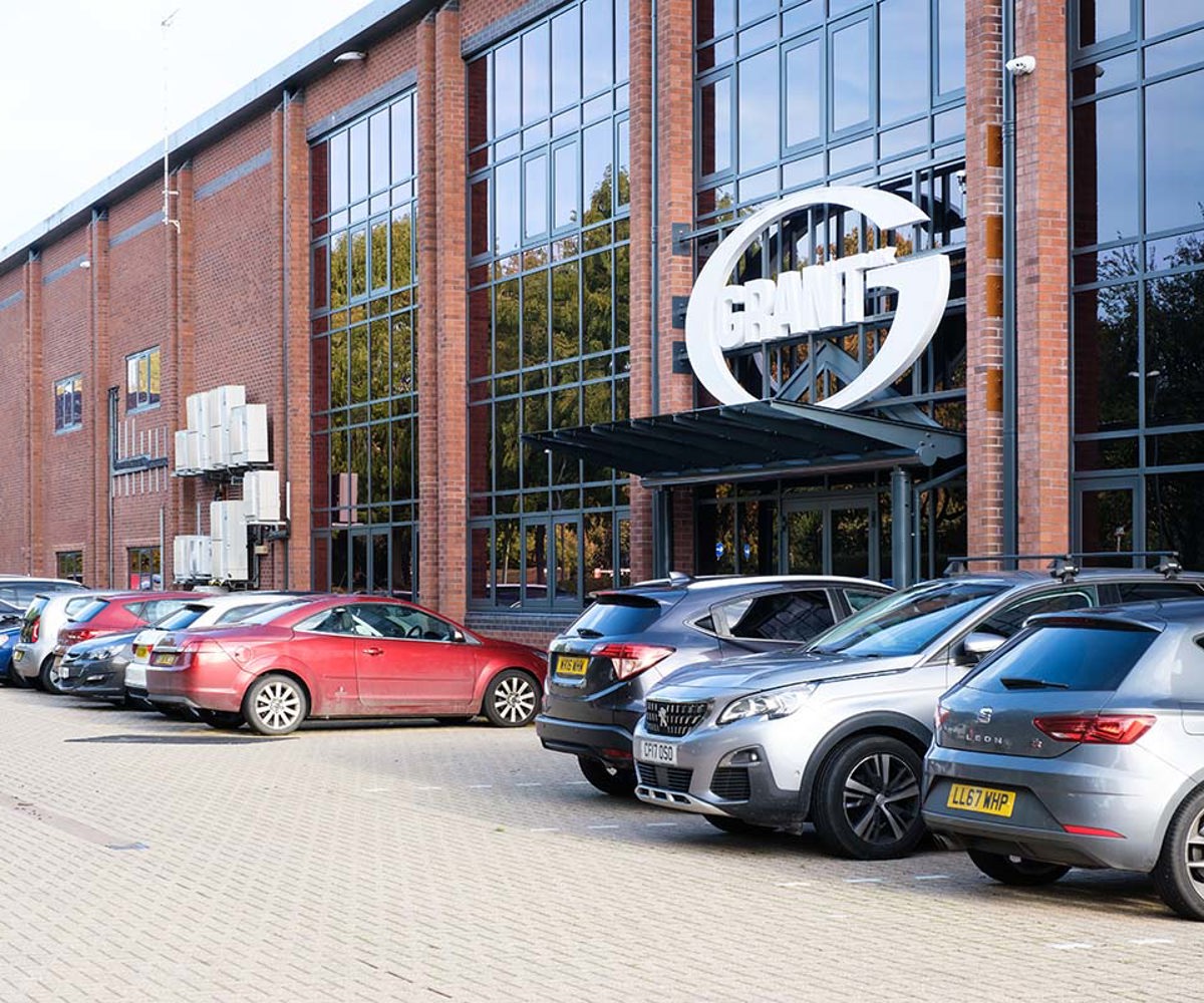 The exterior of Grant UK offices with cars parked outside